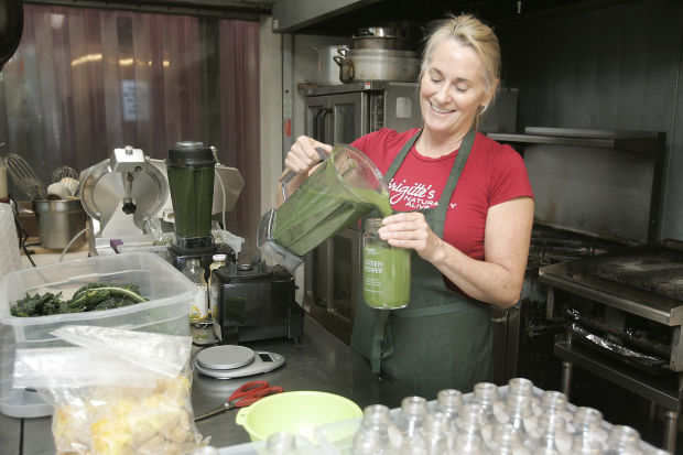 Brigitte creating smoothies in a commercial kitchen. 